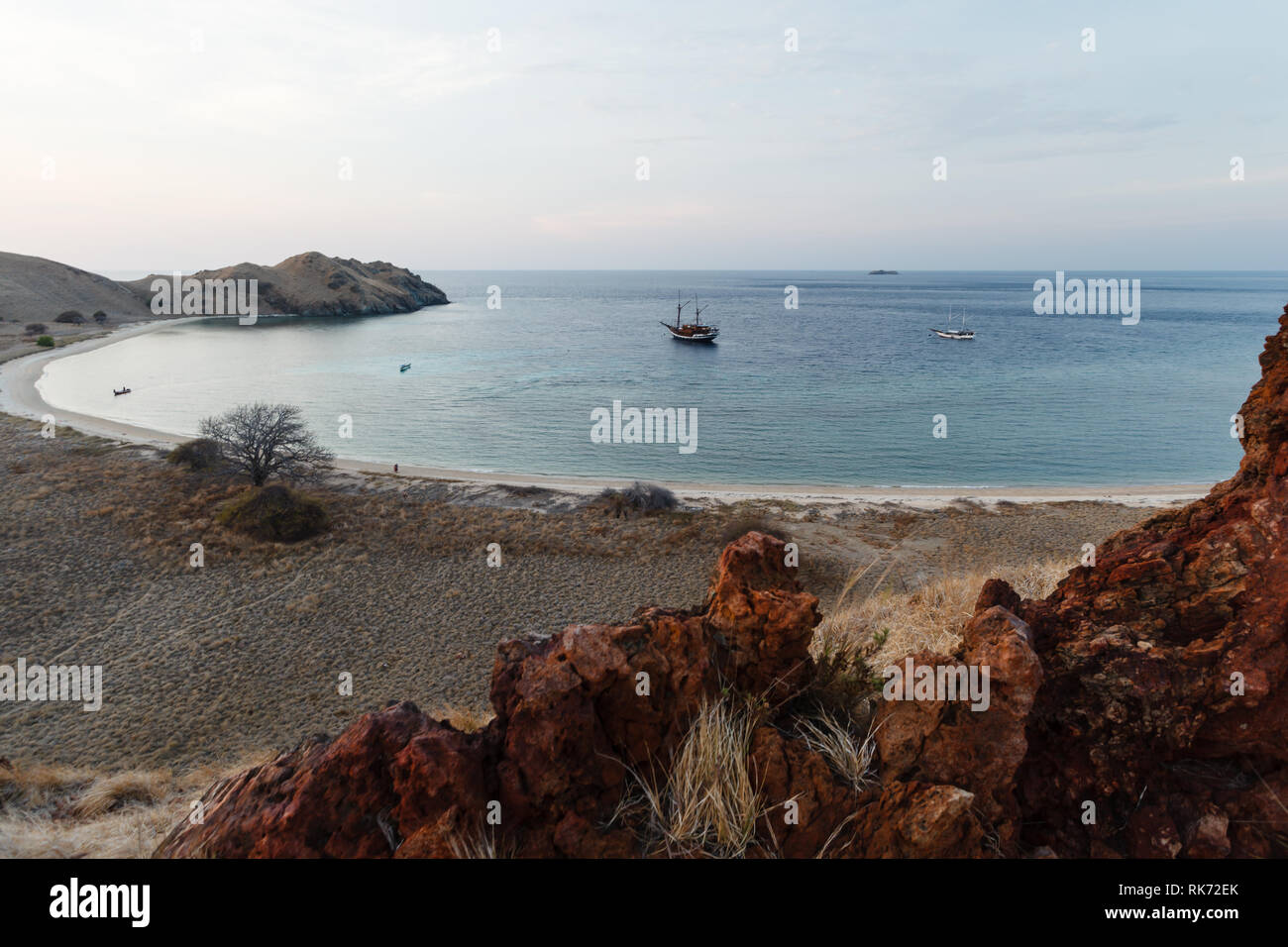Cove at Pulau Lawalaut island with two boats moored inside Stock Photo