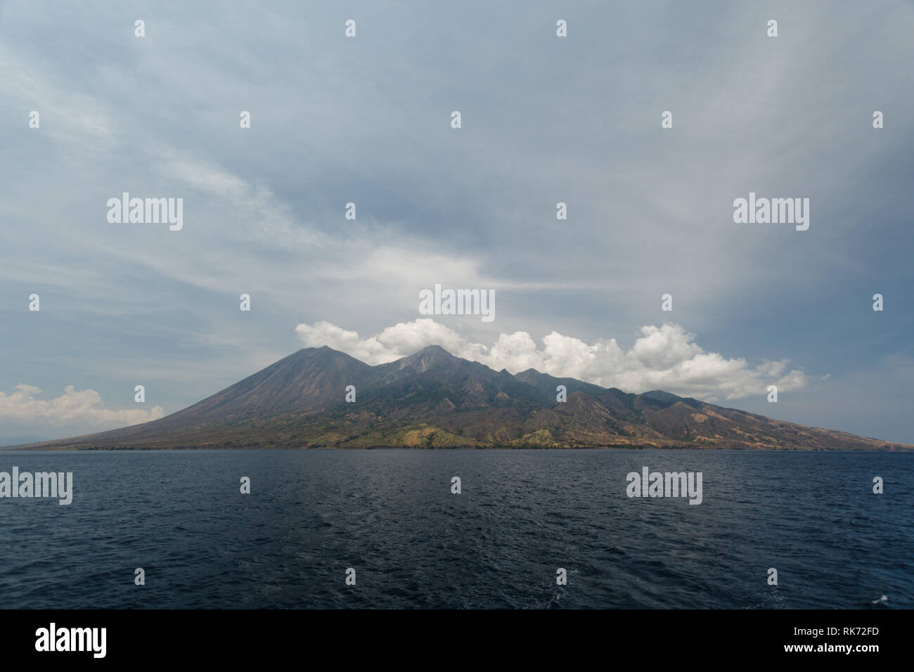 Ring of Fire island, Pulau Sangeang island  produces steam from its volcano Stock Photo