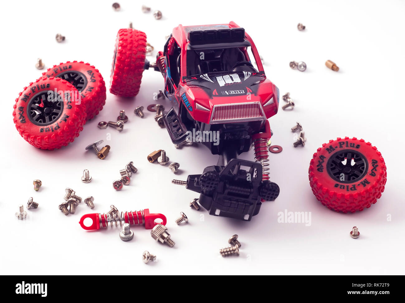 Disassembled car and scattered parts. Broken toy Stock Photo