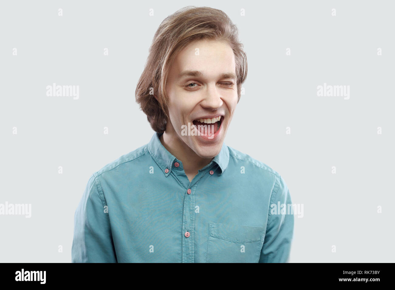 Portrait Of Funny Happy Handsome Long Haired Blonde Young Man In