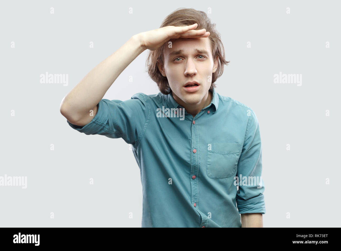 Portrait Of Attentive Handsome Long Haired Blonde Young Man In
