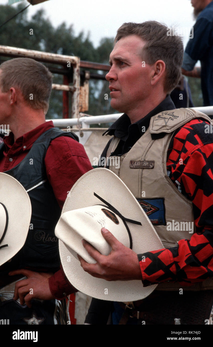 A quiet and emotional moment as the finals for the Bull Busters pledge allegiance to sand and soil with the Australian national anthem.     Bull ridin Stock Photo