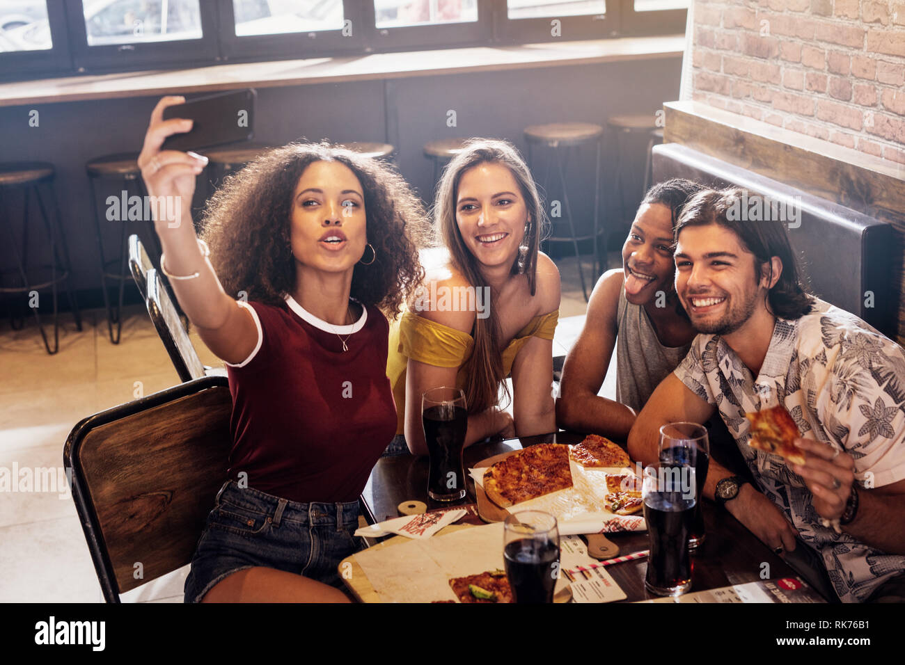 Group of friends making a selfie at restaurant. Multi-ethnic man and ...