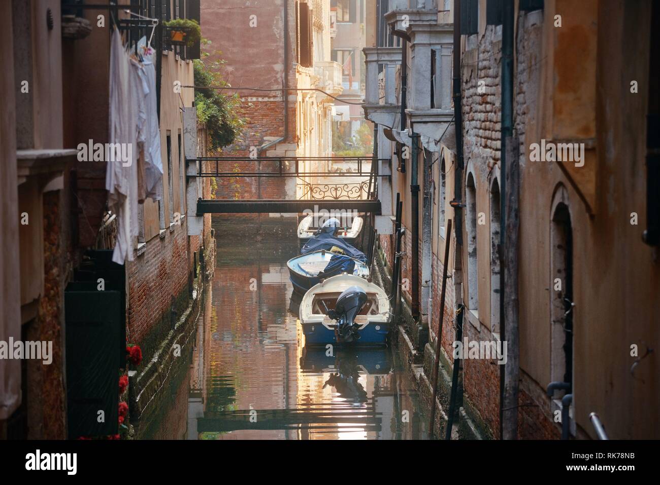 Boat park in Venice alley canal. Italy Stock Photo - Alamy