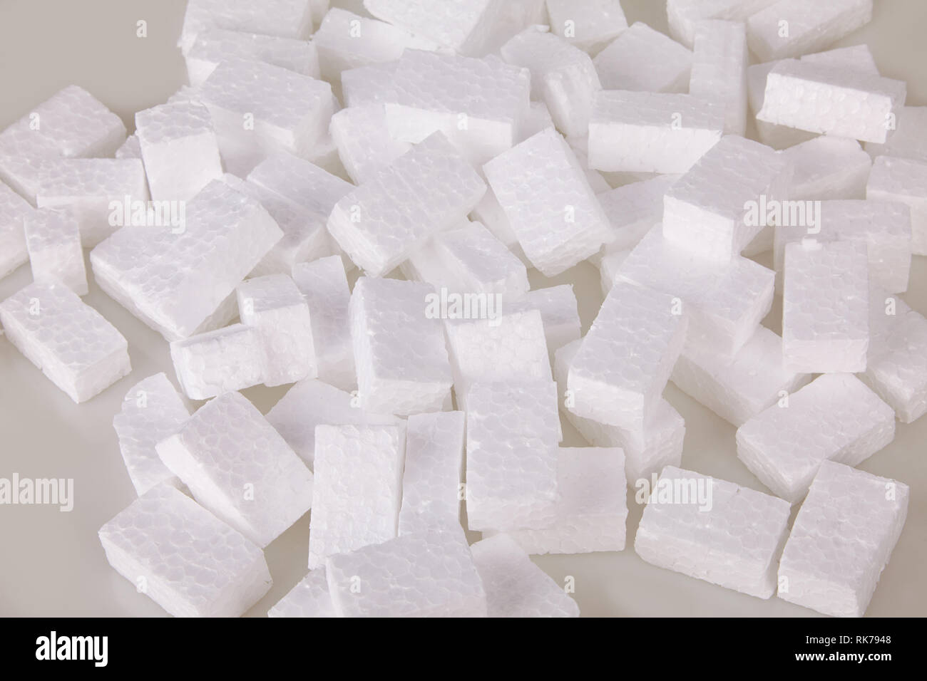 Filler packing background. Packaging foam pellets texture, top view, close-up. Polystyrene, white styrofoam packing peanuts used to prevent damage to Stock Photo