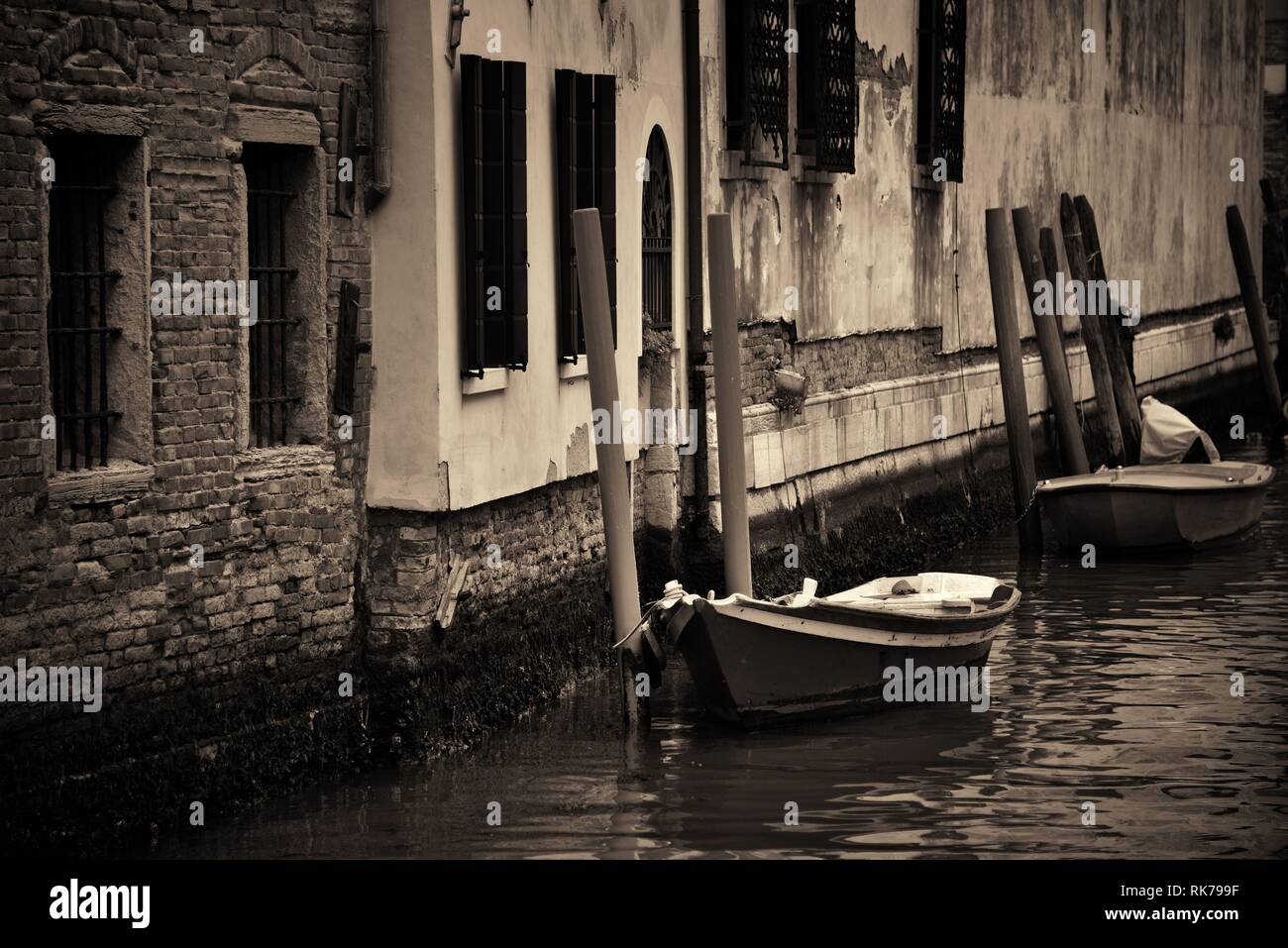 Boat park in Venice alley canal. Italy Stock Photo - Alamy