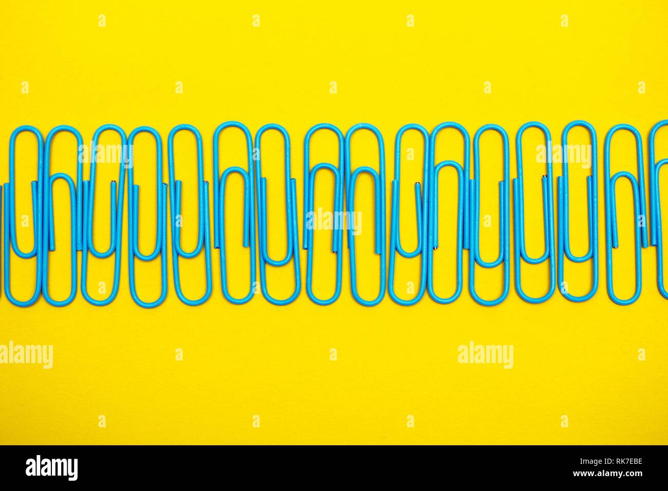 set of stationery - blue clips on a yellow background Stock Photo