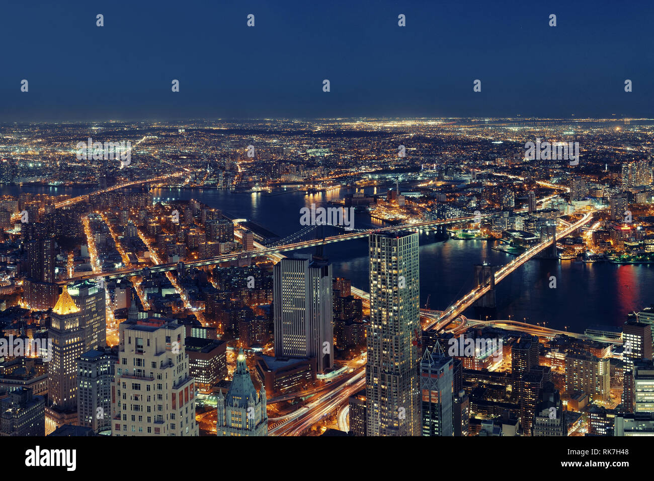 Rooftop night view of New York City downtown with urban skyscrapers ...