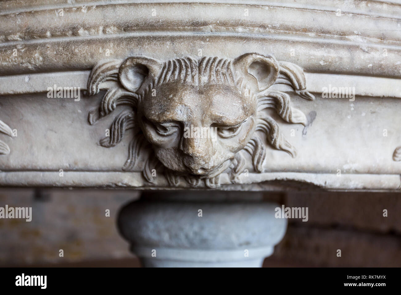 Medieval lions head carved out of stone at base of large stone bowl in Castle at Carcassonne, France on 11 June 2015 Stock Photo