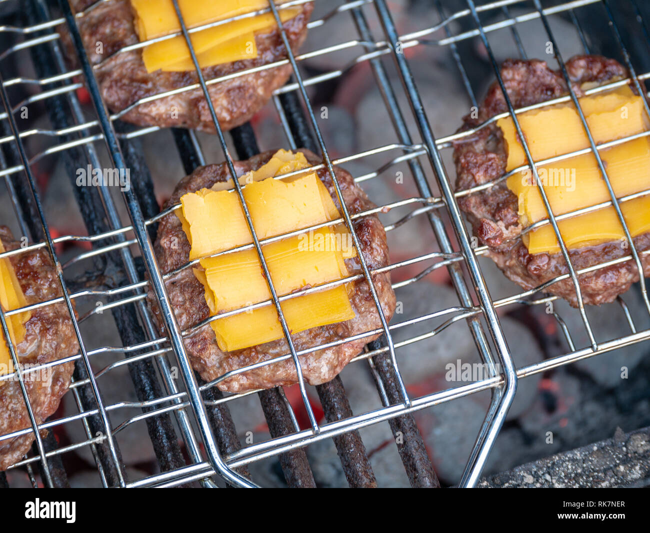 Image of bbq burger patties with cheese on grill Stock Photo