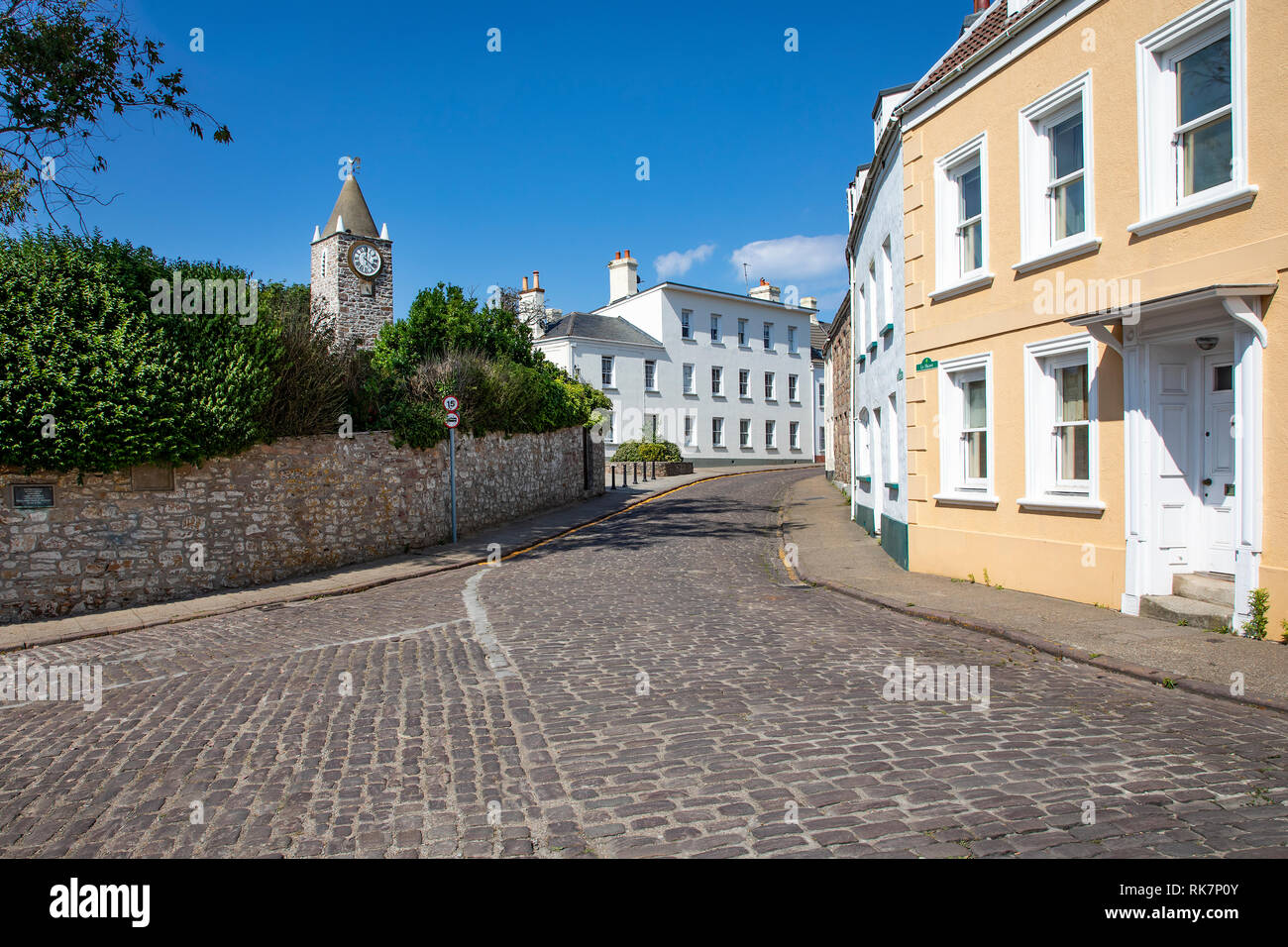 The clock tower and museum entrance at the top of the High Street on Alderney Channel Islands. Stock Photo