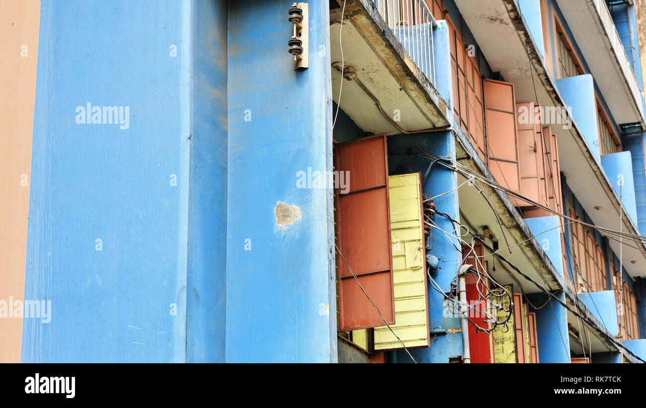 Blue and pink painted facade of a six story apartment building in Ongpin Street-Binondo District-oldest Chinatown in the world founded by the Spanish  Stock Photo