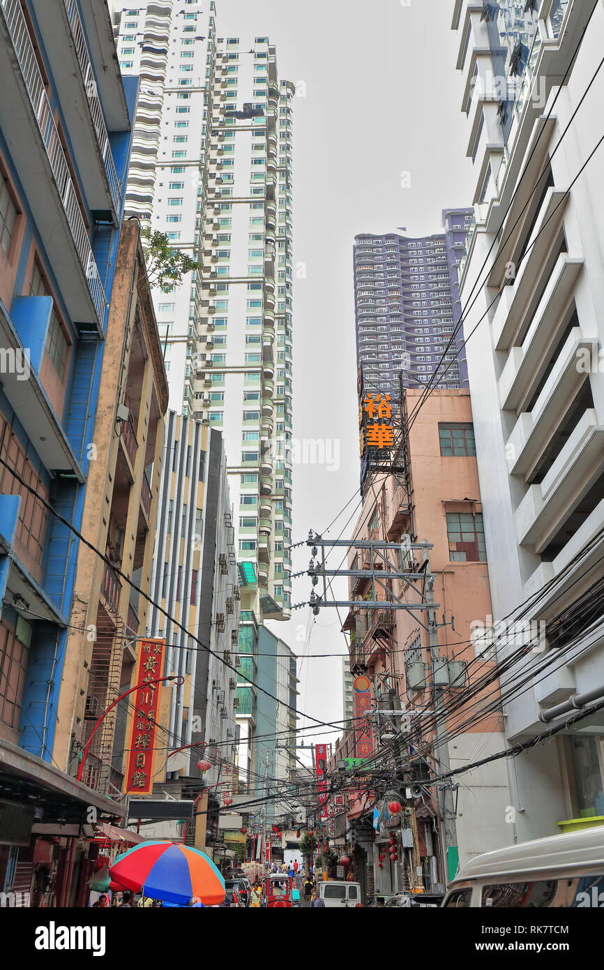 Gigantic mess of electric cables placed between the high-rise condominium buildings outlining Ongpin Street of Binondo district-oldest Chinatown in th Stock Photo