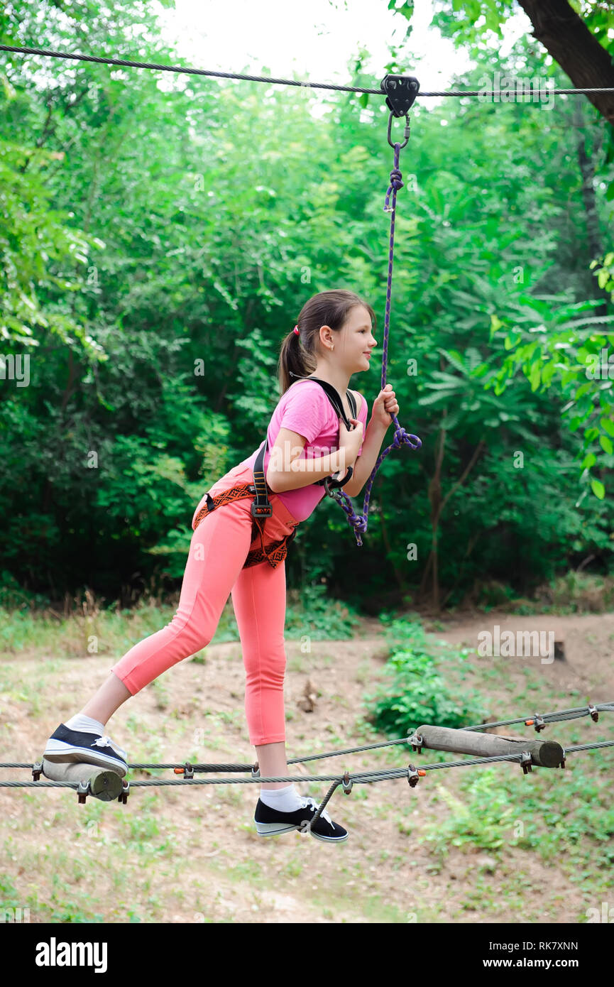 adventure climbing high wire park hiking in the rope park girl Stock