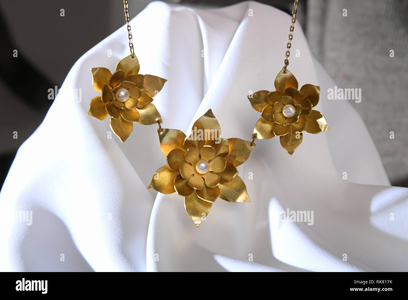 Vintage brass jewelry necklace with pearl on the white satin, hand made