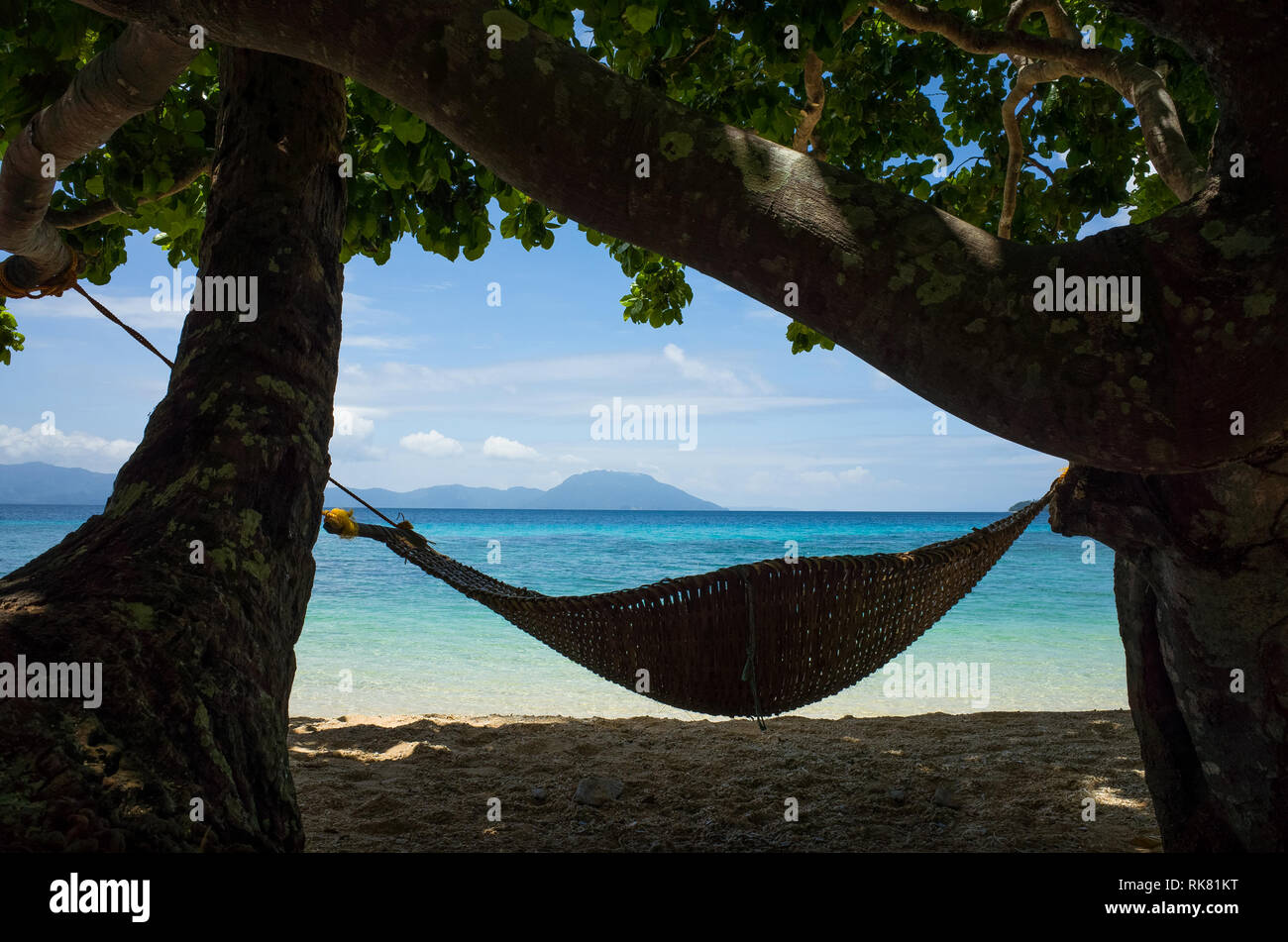 Bamboo Hammock, a Woven native style relaxation bed, with tropical sea and beach - Romblon Island, Philippines Stock Photo