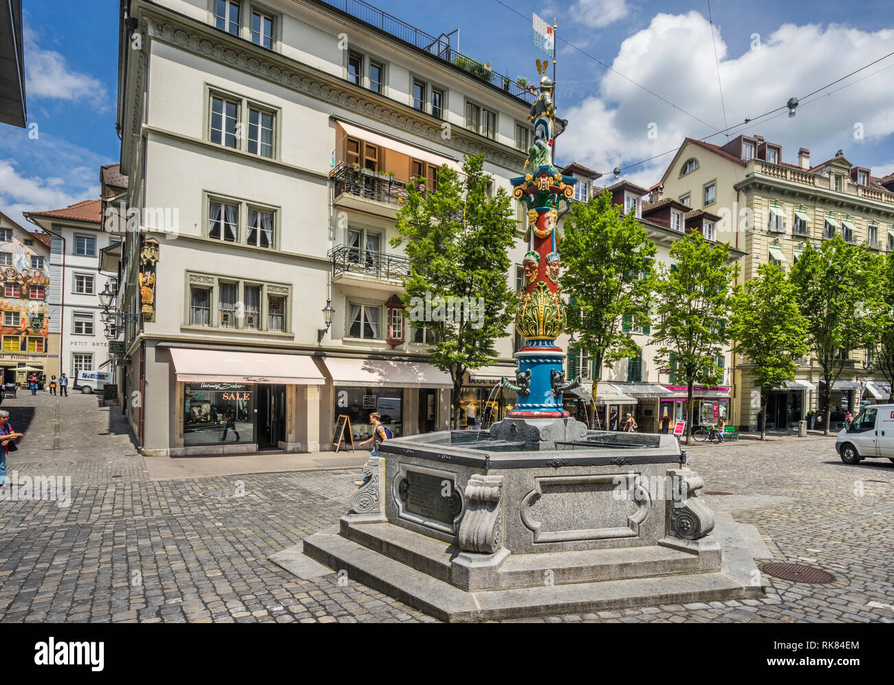 hexagonal neo-Renaissance style Fritsch fountain with painted figures and fools' masks on Kapellplatz (Chapel Square) in the Old town of Lucerne, Cant Stock Photo