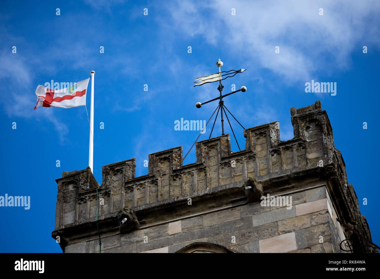 English Saint George flag flying over a medieval church tower against a ...