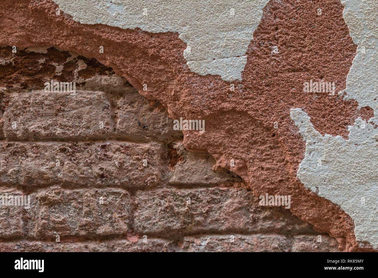 Brick Wall with Deteriorated Stucco Stock Photo