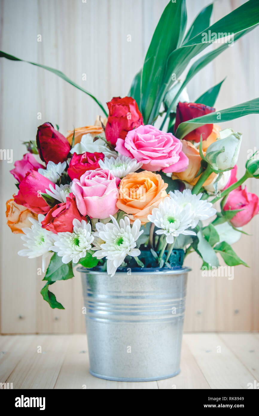 Vase Of Bouquet Roses In Aluminium Bucket On Wooden Table Set Of