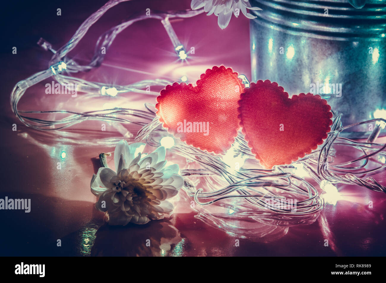 Red glittering heart and lighting bulb with aluminium bucket on pink  background. Illuminate light of love in Valentine day concept Stock Photo -  Alamy