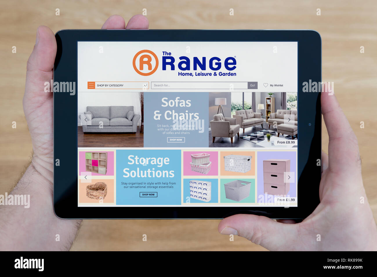 Range Website A man looks at The Range website on his iPad tablet device, shot ...