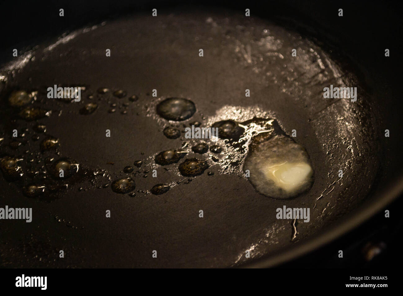 Melted butter sizzling in a nonstick teflon pan Stock Photo