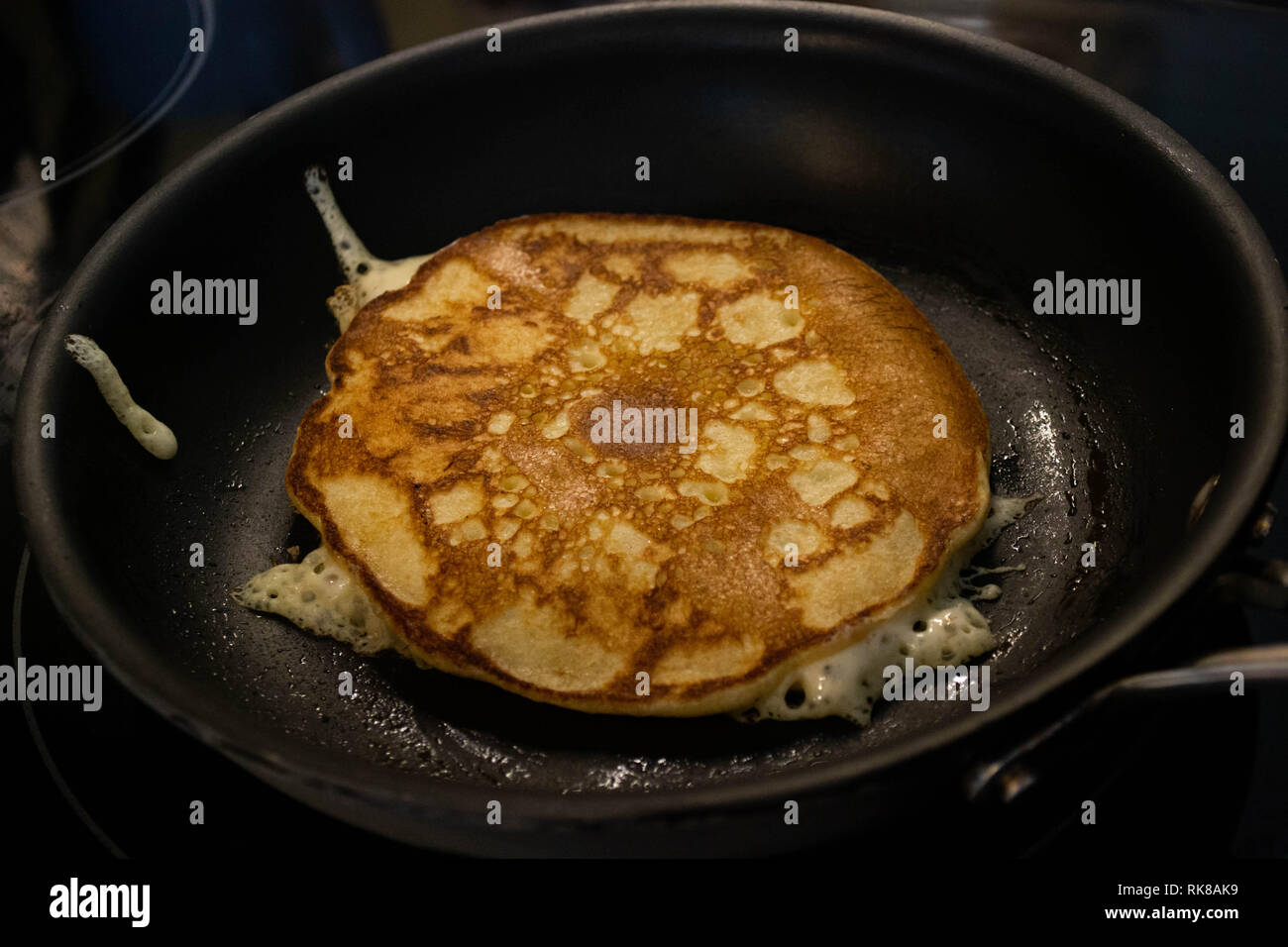 Sourdough pancakes frying in a nonstick teflon pan Stock Photo Alamy