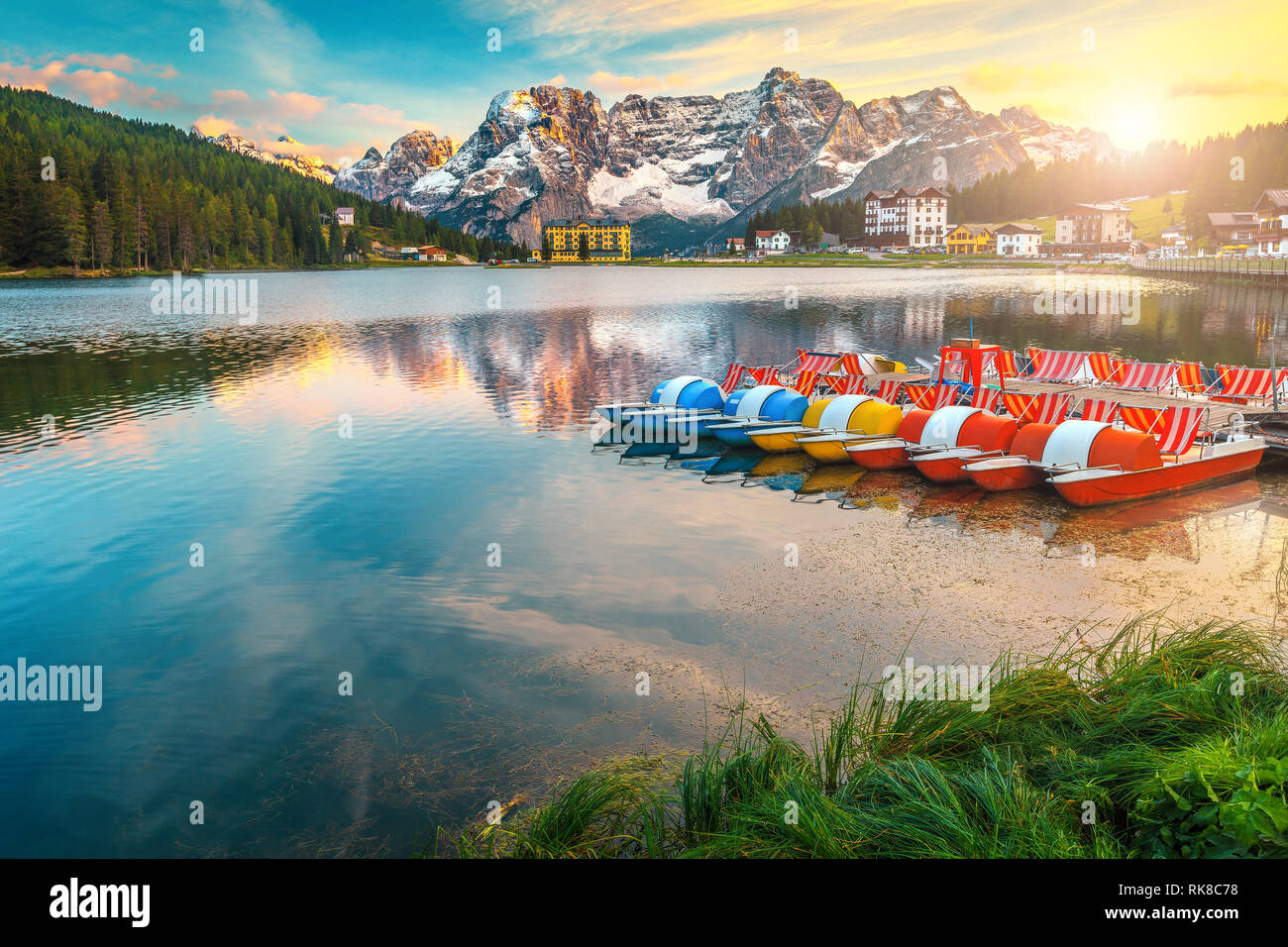Breathtaking sunset and famous alpine Misurina lake. High Sorapis mountain group in background and spectacular Misurina lake with colorful boats at su Stock Photo