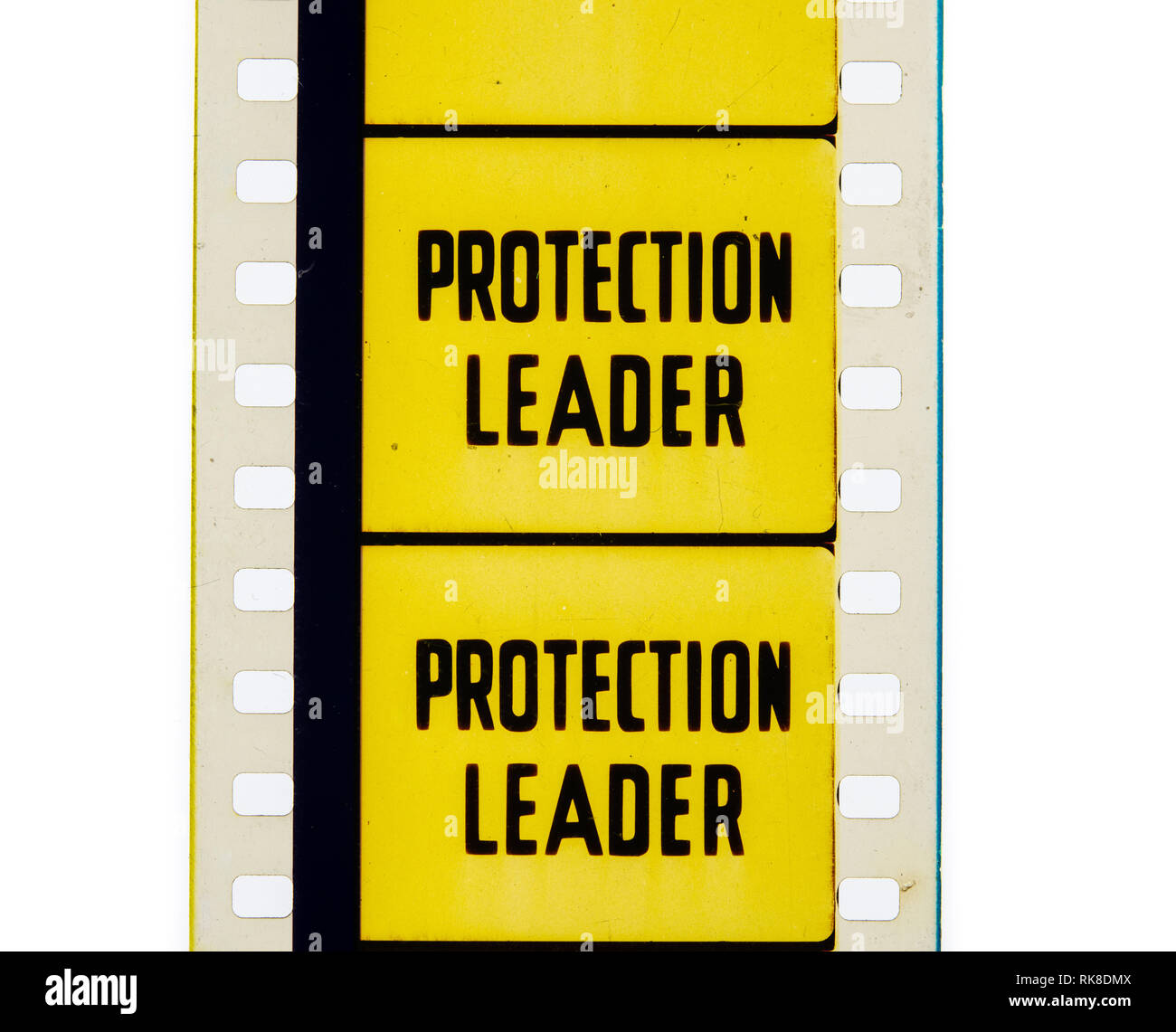 Extreme close up of 35mm movie film strip with protection leader text on yellow Stock Photo