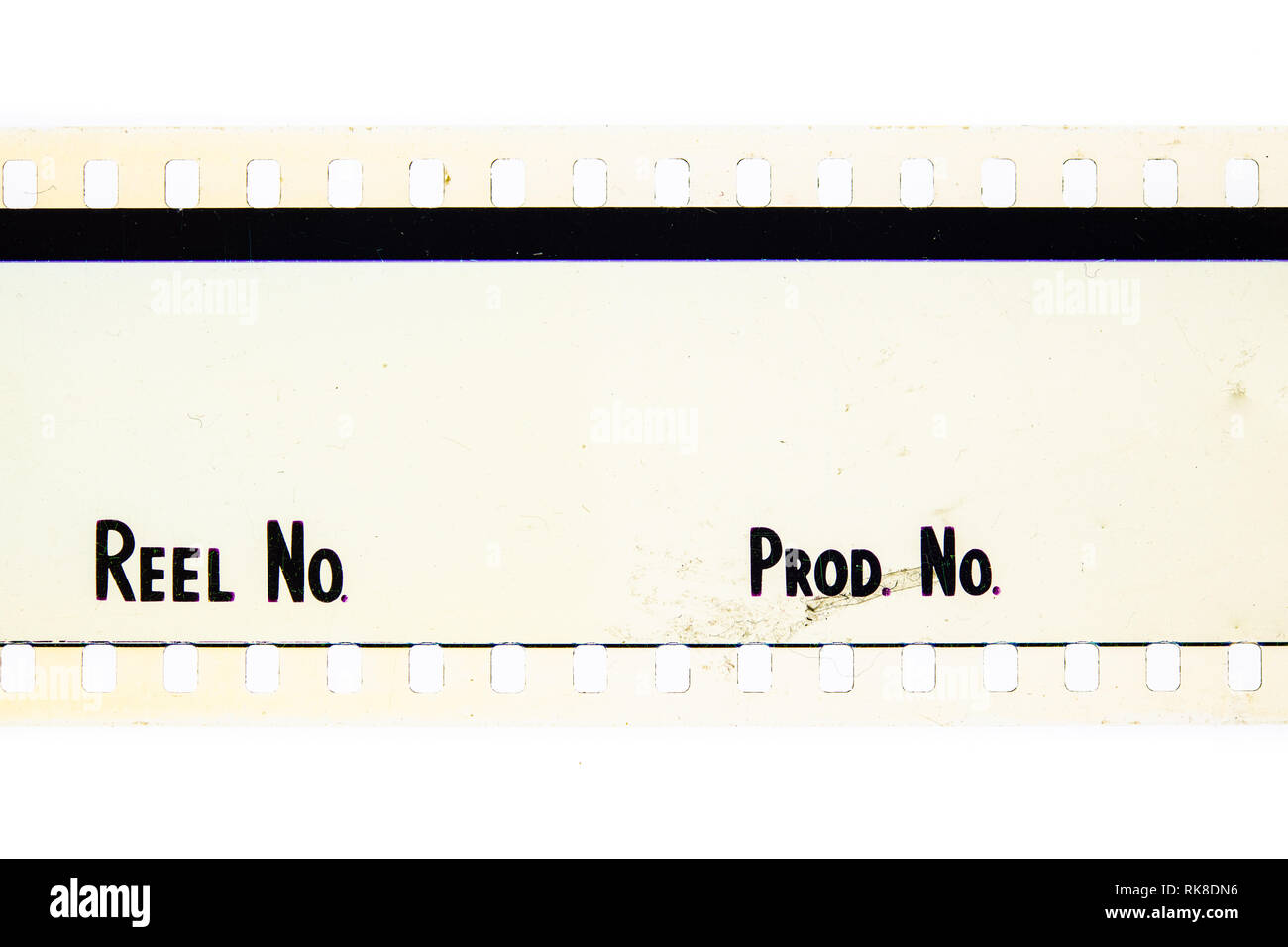 Extreme close up of 35mm movie film strip with reel and movie production text message on white Stock Photo
