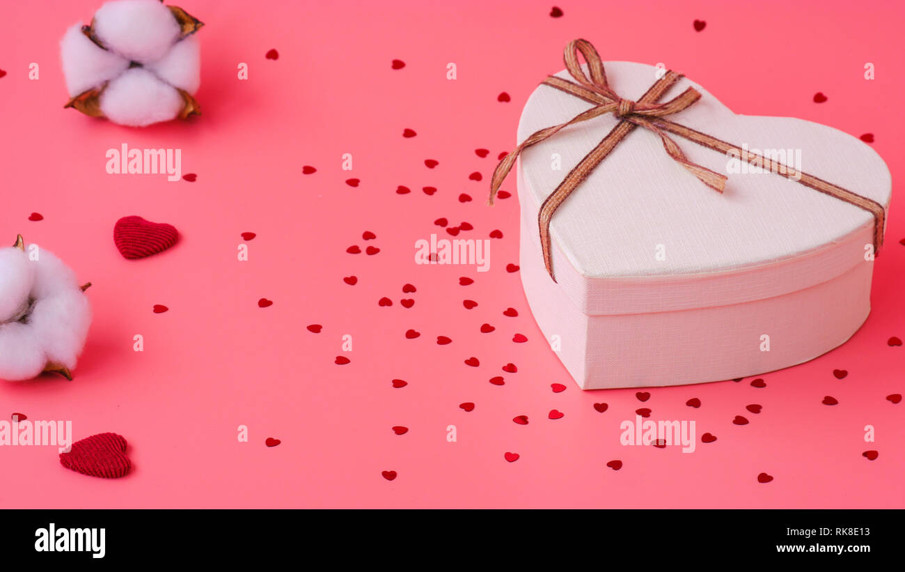 St. Valentine day background. Gift box with gold ribbon and lights on a ...