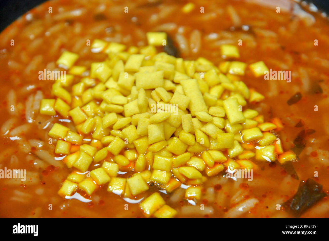 Tomato soup with Soup Almonds AKA soup mandel an Israeli food product consisting of crisp mini croutons that are added to soup at the table Stock Photo