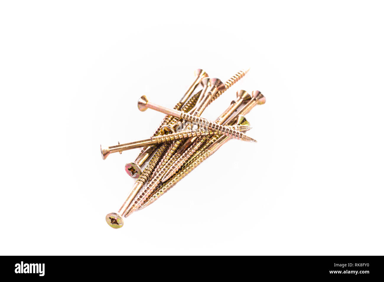 Bunch of yellow zinc coated philips screws on white background Stock