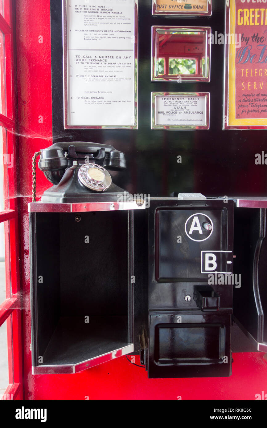 The interior of a UK public phone box (K6 Button A and Button B prepayment phone) at the Postal Museum, Mount Pleasant, London, England, UK Stock Photo