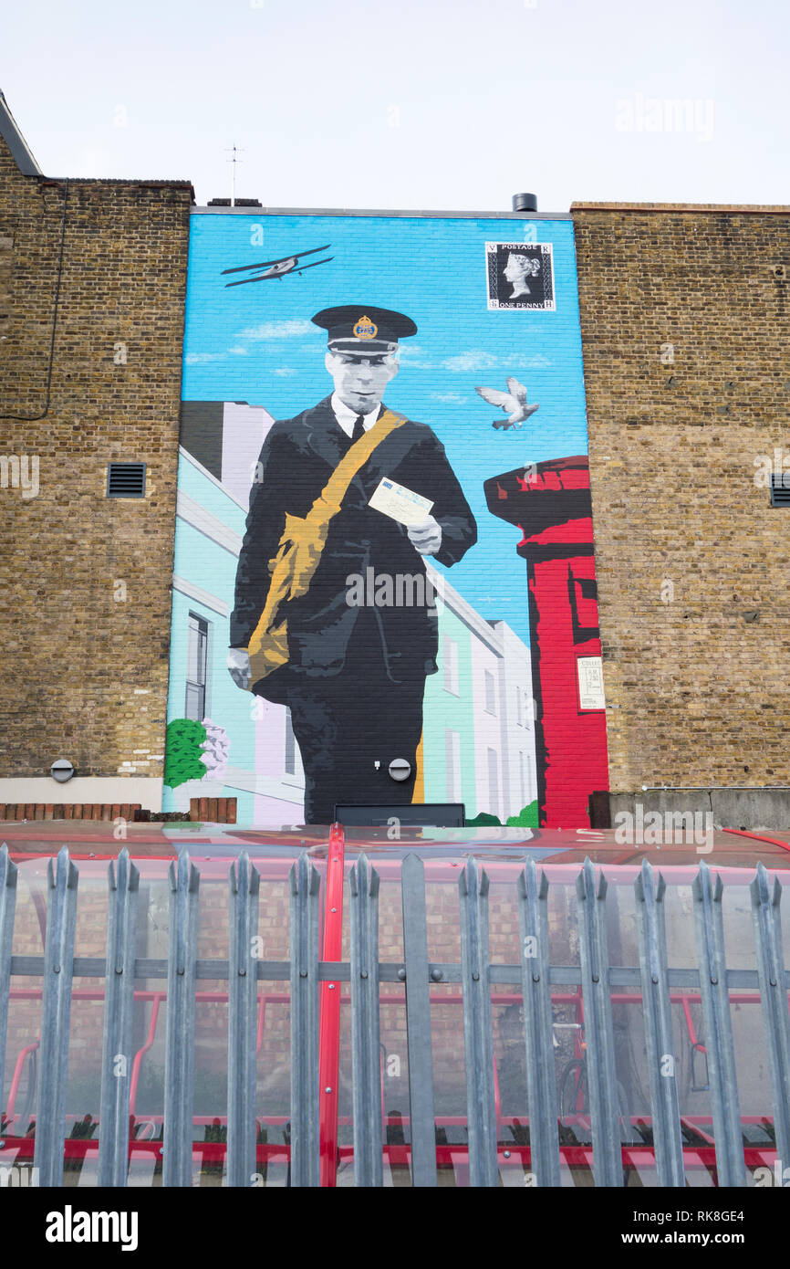 A Postman painted on a wall outside the The Mount Pleasant Mail Centre Museum, Farringdon Road, London, EC1, UK Stock Photo