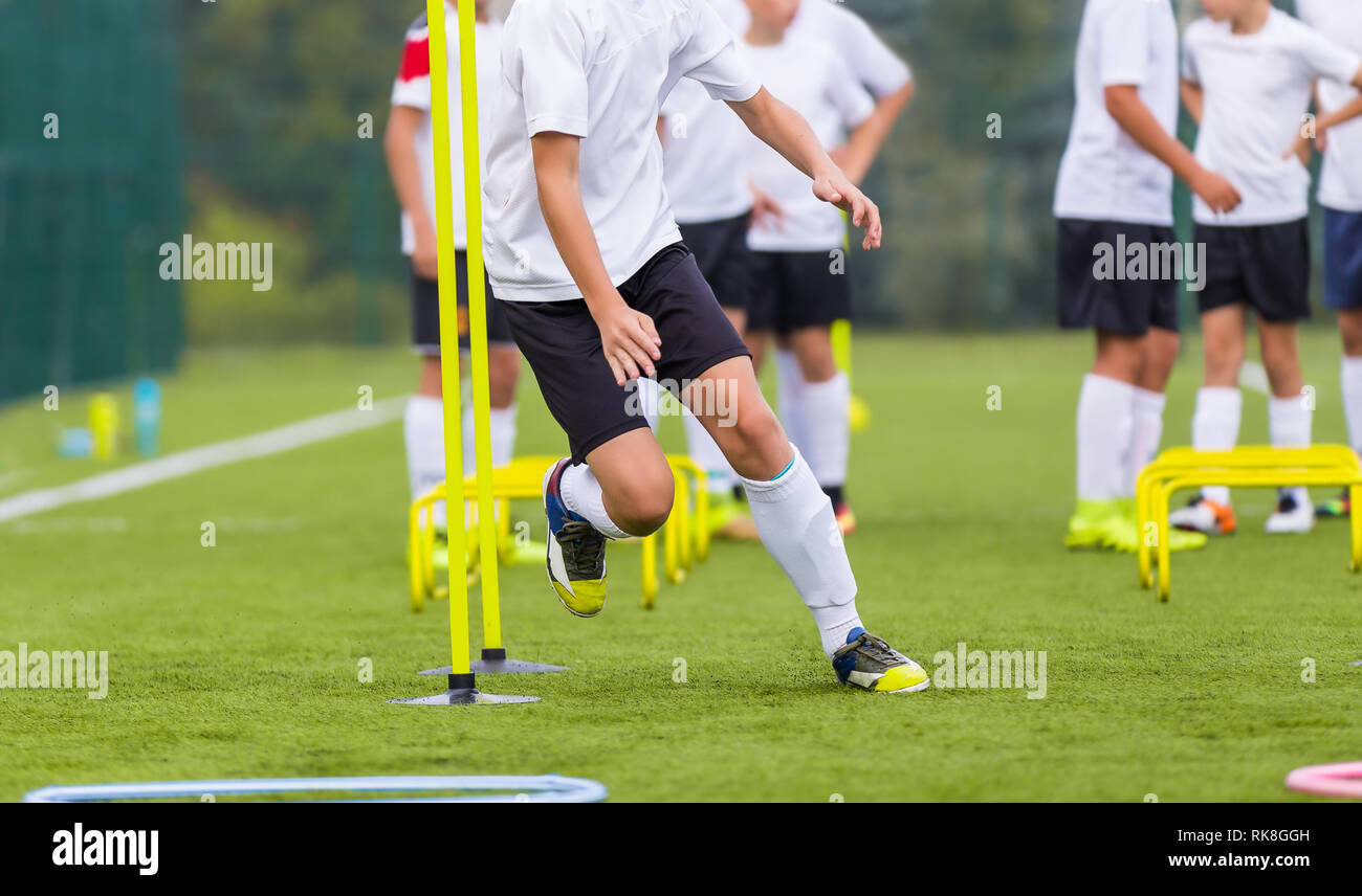 Boy Soccer Player In Training. Boy Running Between Cones During