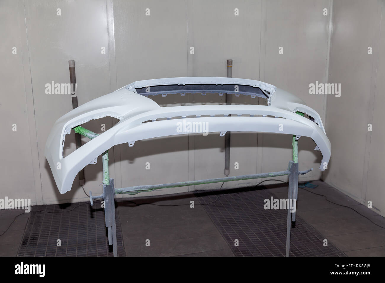 Repair of the rear bumper of a white car after an accident with the