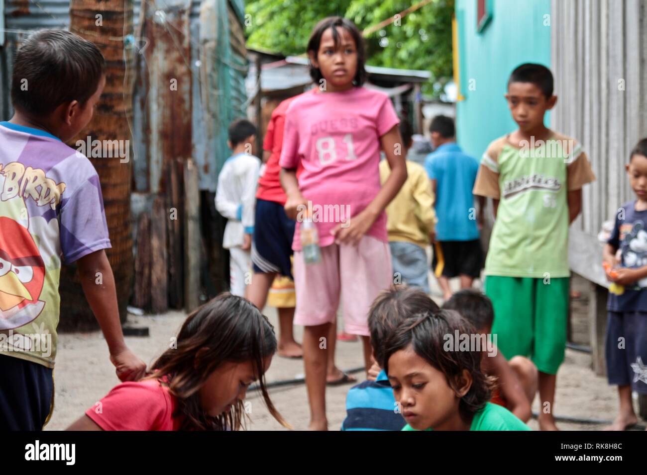 Indonesian kids playing marbles Stock Photo
