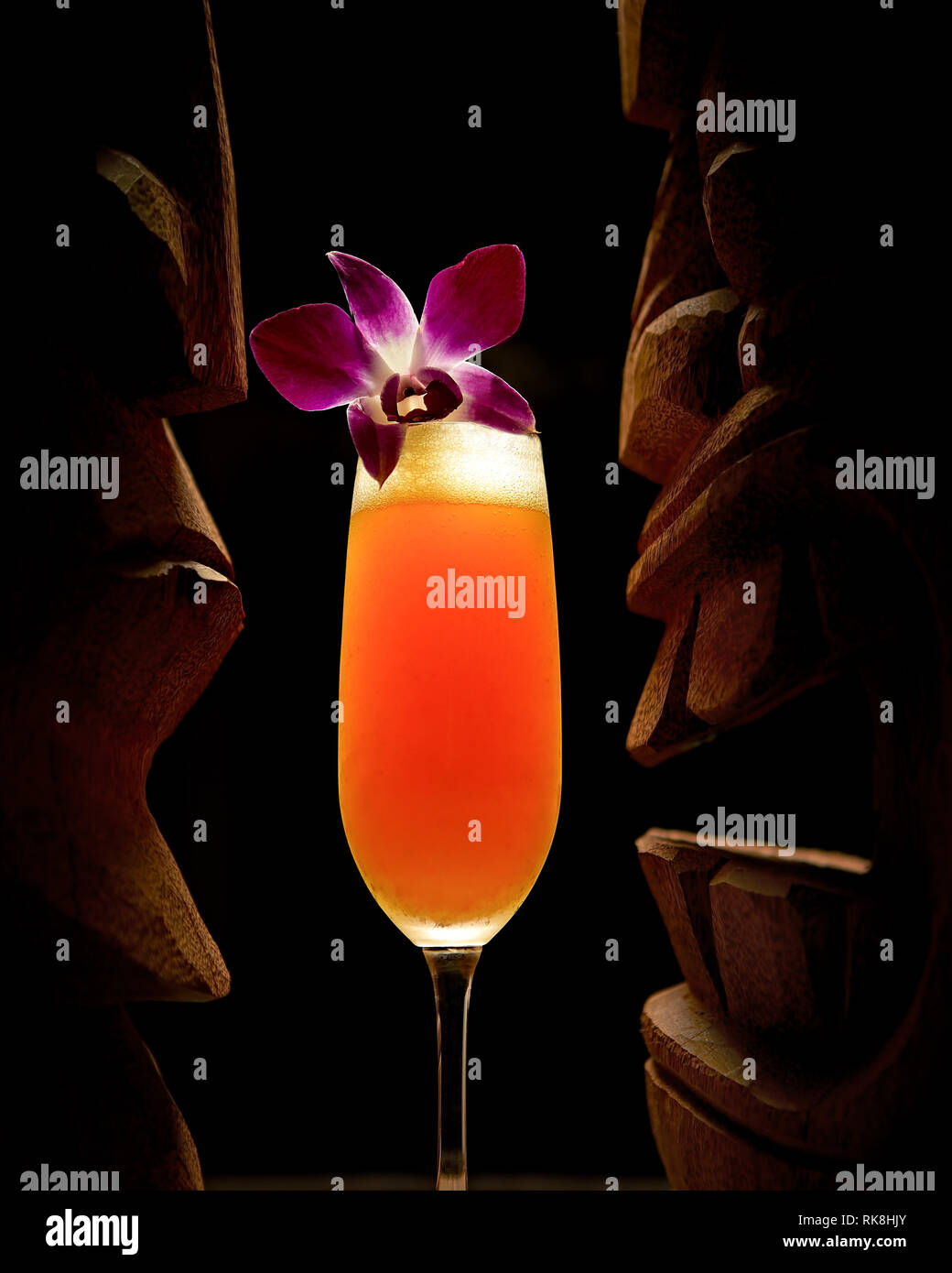 Fruity Champagne cocktail served in a flute with an orchid Stock Photo