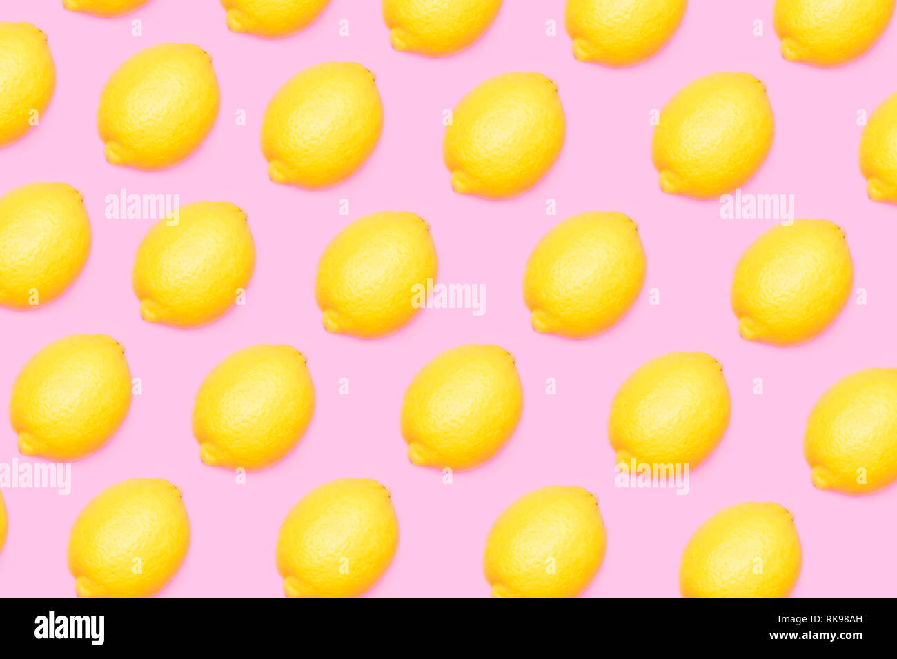 Yellow lemons pattern on pink background Stock Photo