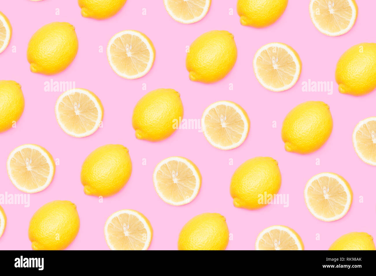 Yellow lemons pattern on pink background Stock Photo