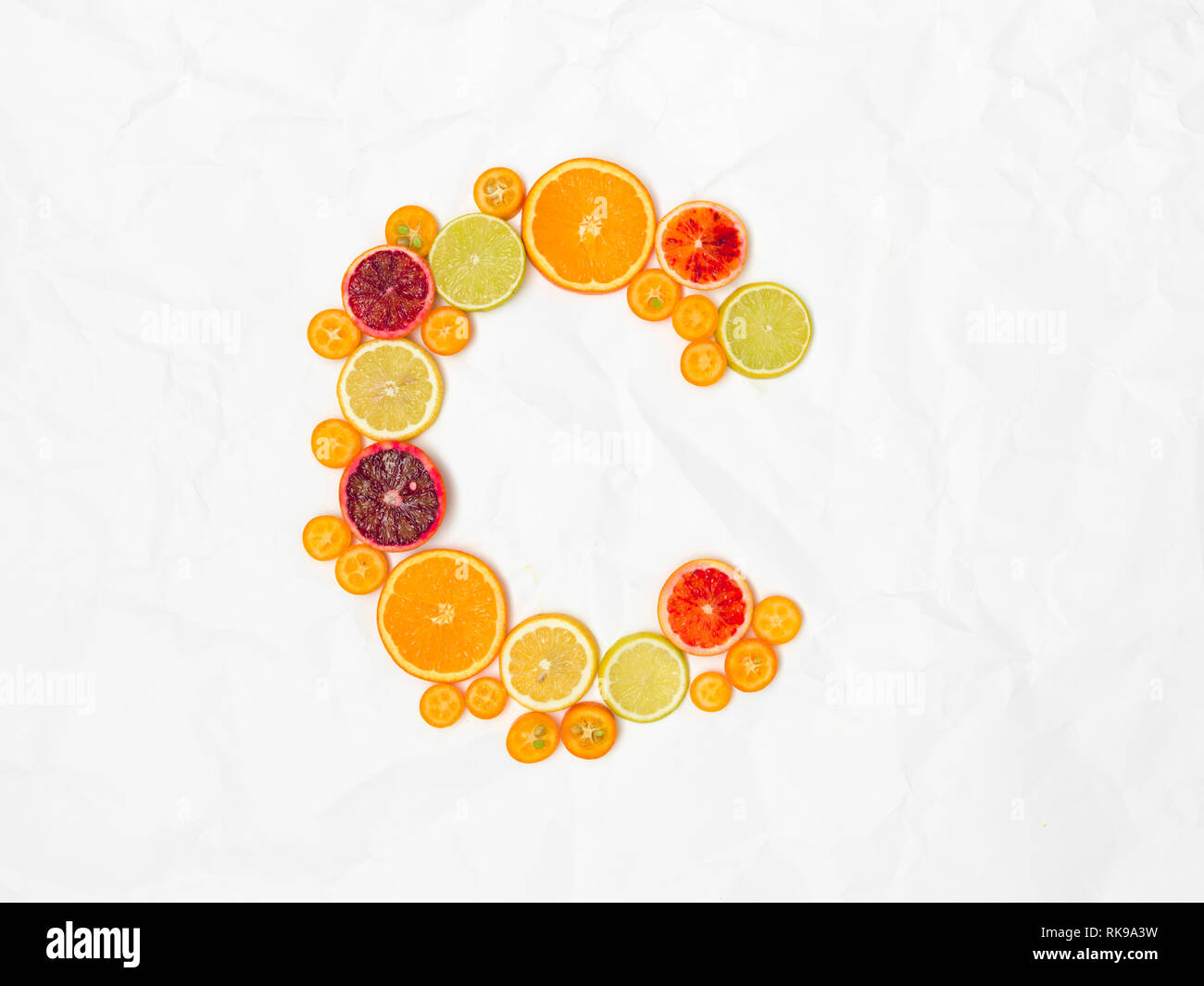 the letter C shaped with different slices of healthy fruits Stock Photo