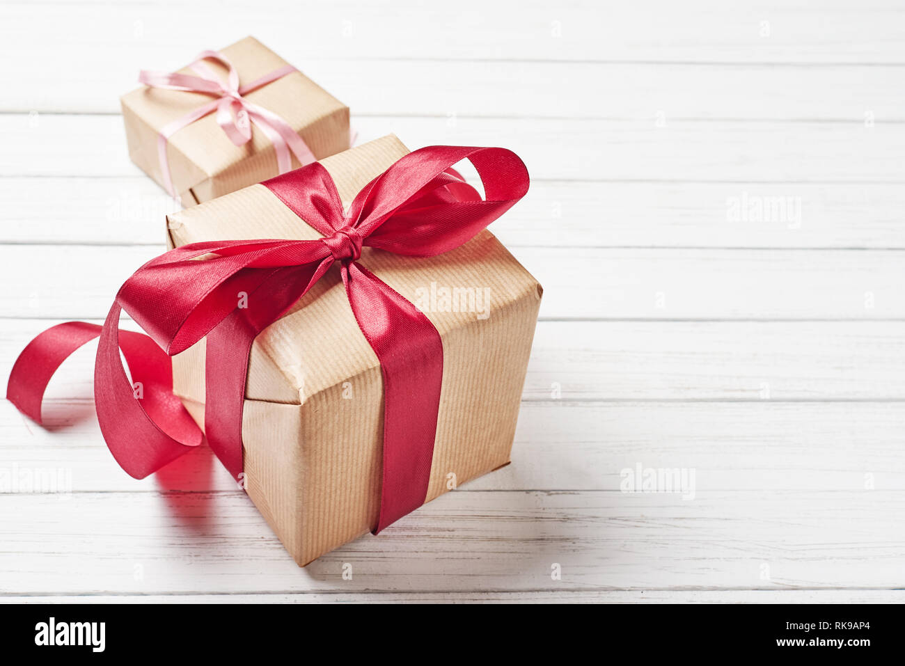 Gift boxes with red bow on white background, copy space Stock Photo - Alamy