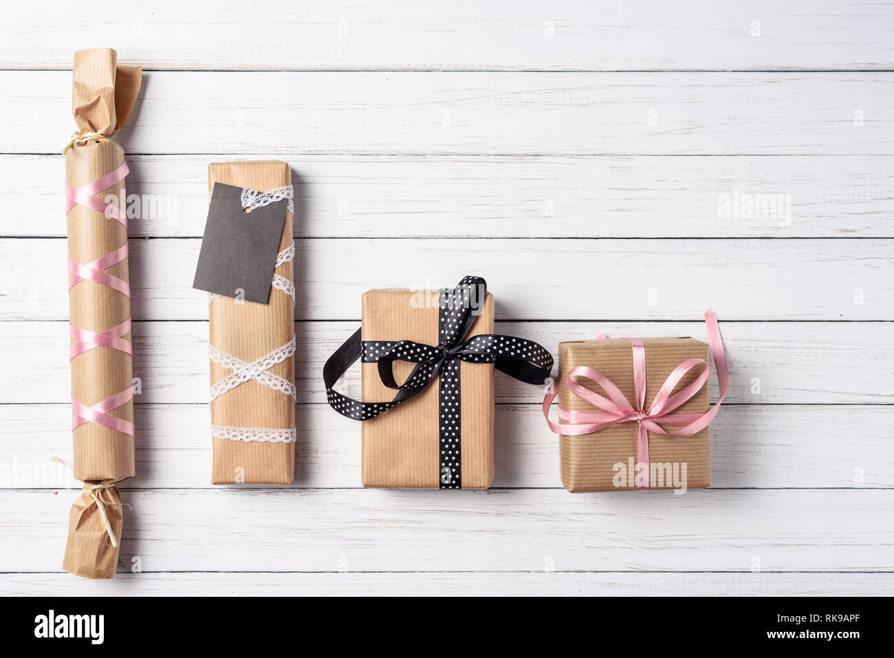 Handmade gift boxed wrapped in craft paper with bow on white wooden ...