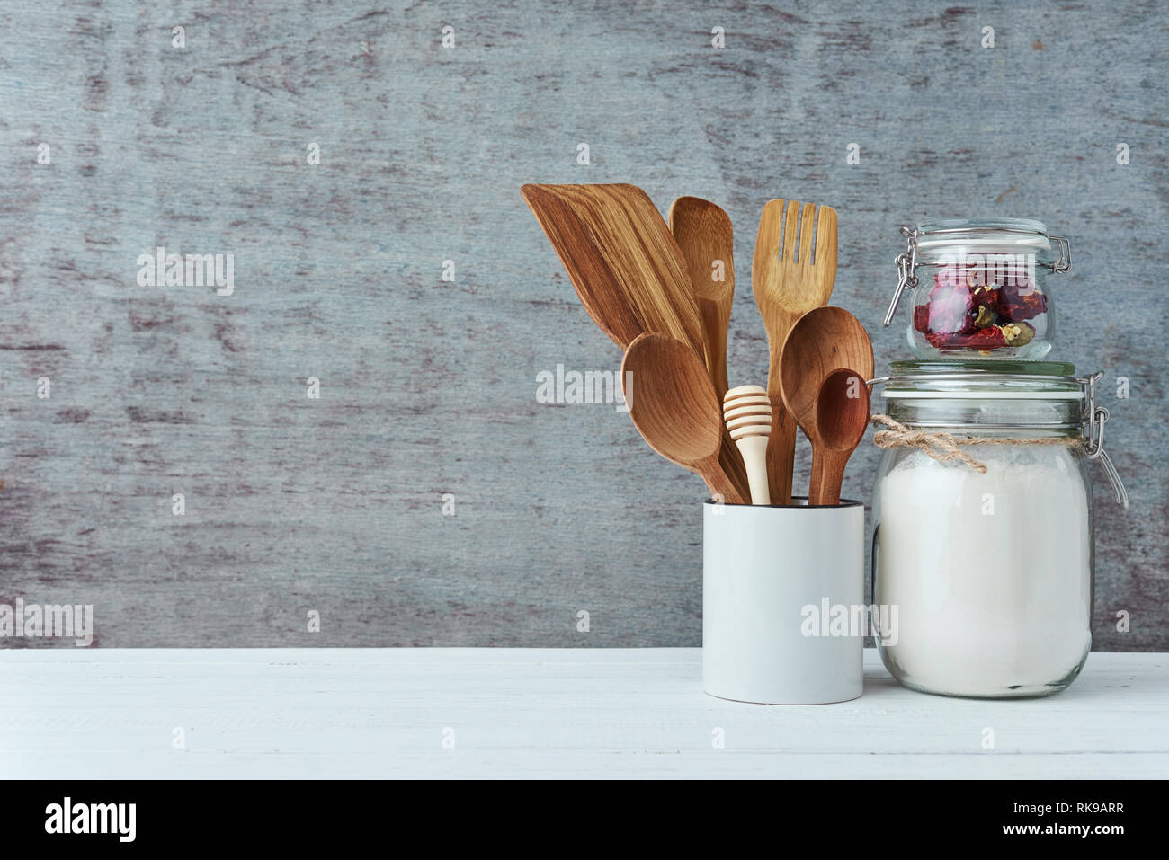 Kitchen utensils in ceramic cup on gray background, copy space Stock Photo
