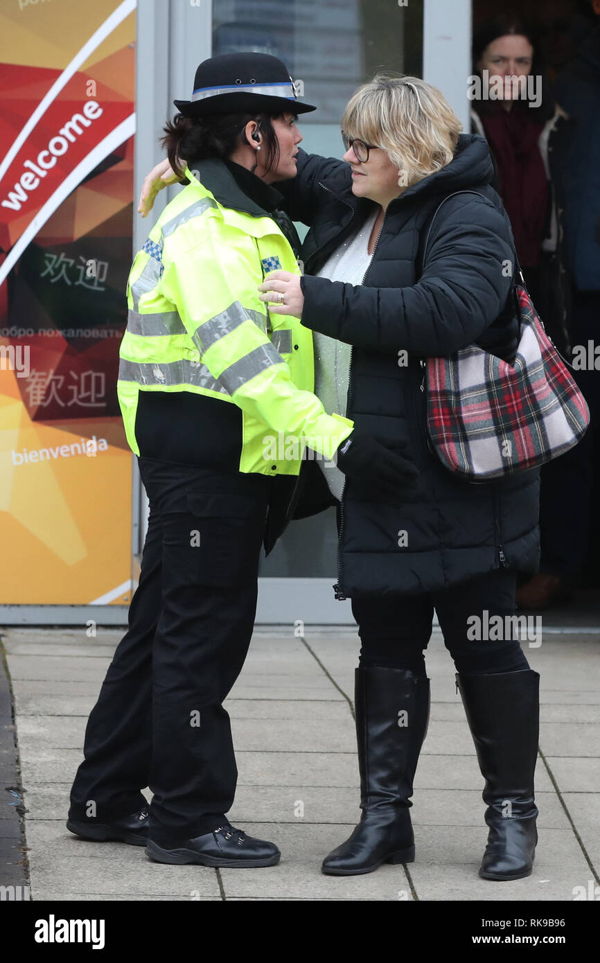 THIS IMAGE FOR ID PURPOSES ONLY!!! Lisa Squire, the mother of missing student Libby Squire, hugs a police officer on leaving a service at Hull Community Church. The 21-year-old student has been missing from her home in the city since February 1st and police have been given more time to question a 24-year-old man who was arrested on suspicion of her abduction on Wednesday. Stock Photo