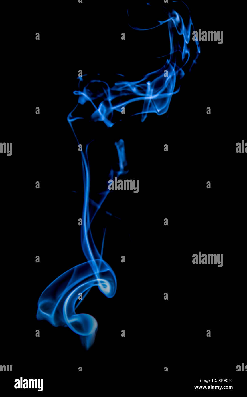 Abstract blue smoke swirls over black background Stock Photo - Alamy