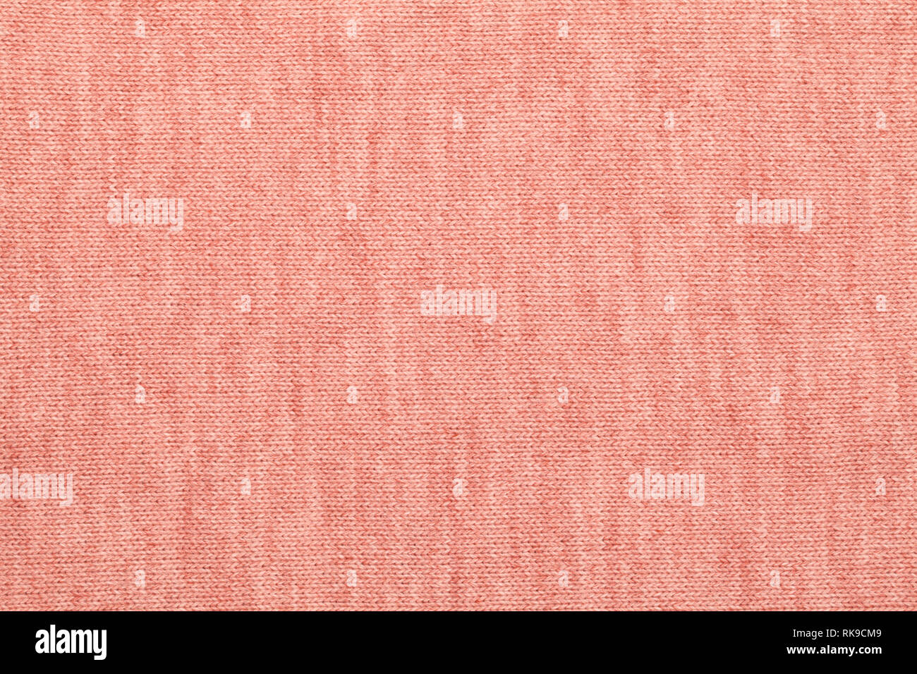 Living coral trendy color of the year 2019 knitted fabric made of heathered yarn textured background Stock Photo
