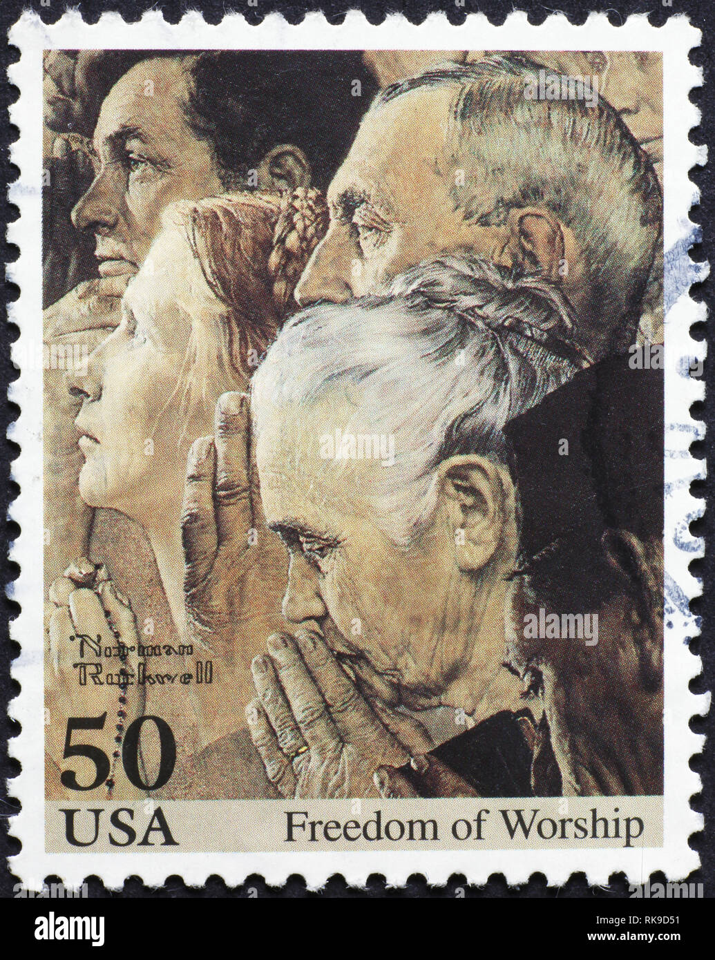People praying by Norman Rockwell on american stamp Stock Photo